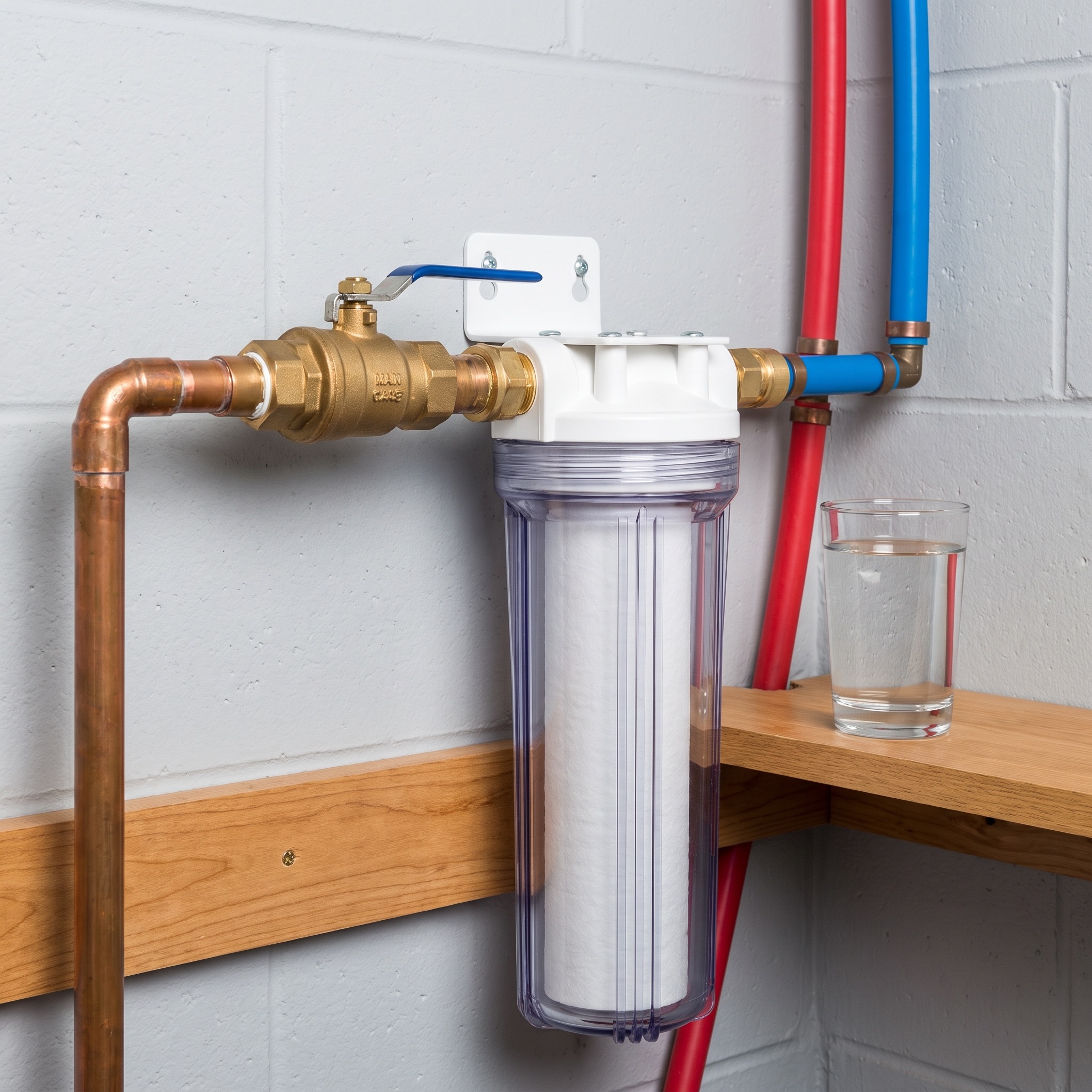 Colorado Water Contaminants and Whole House Filtration Older Colorado home plumbing showing mineral buildup where copper pipe meets newer PEX connection